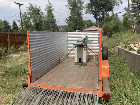 Planing machine strapped for transport